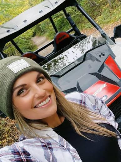 Samantha Kay Bose smiling in an off-road vehicle