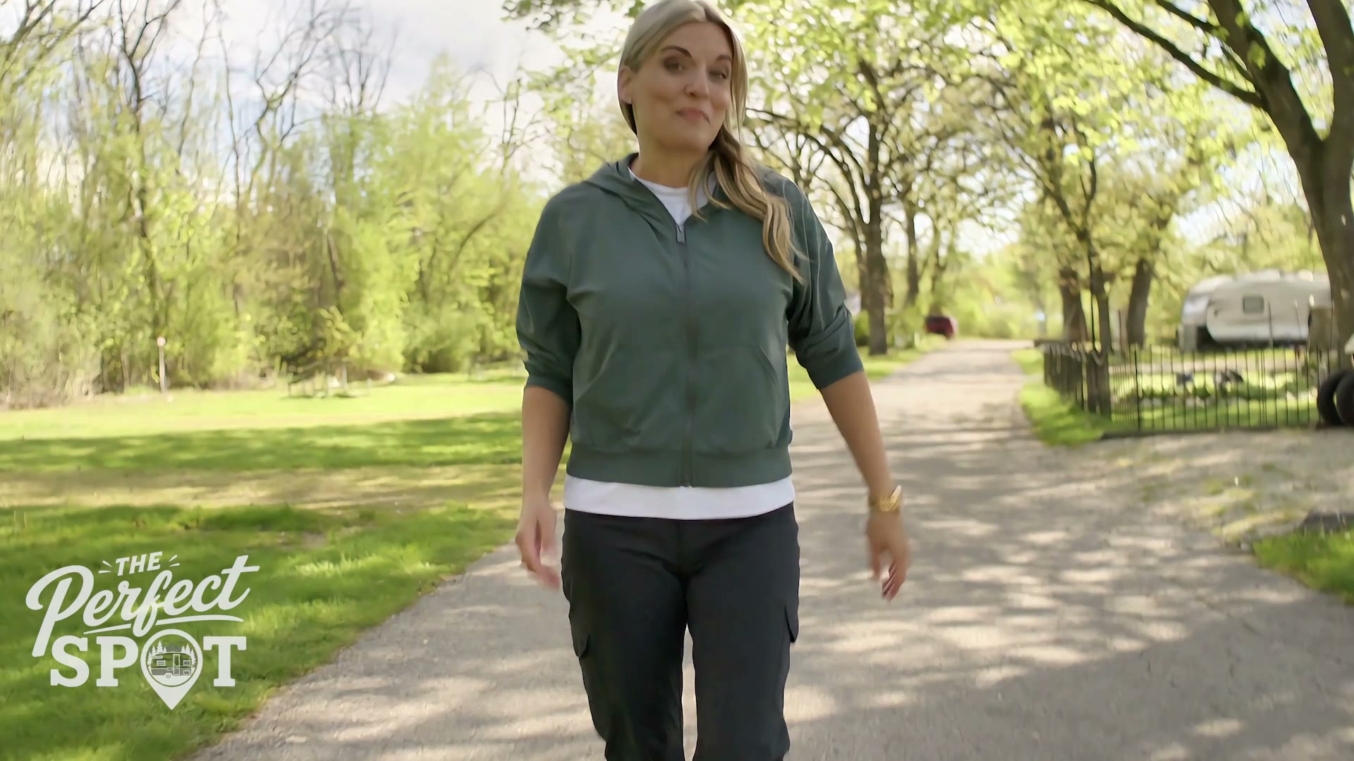 Samantha Kay Bose walking through a tree-lined campground while filming The Perfect Spot